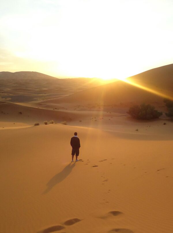 Single person walking in the golden Sahara