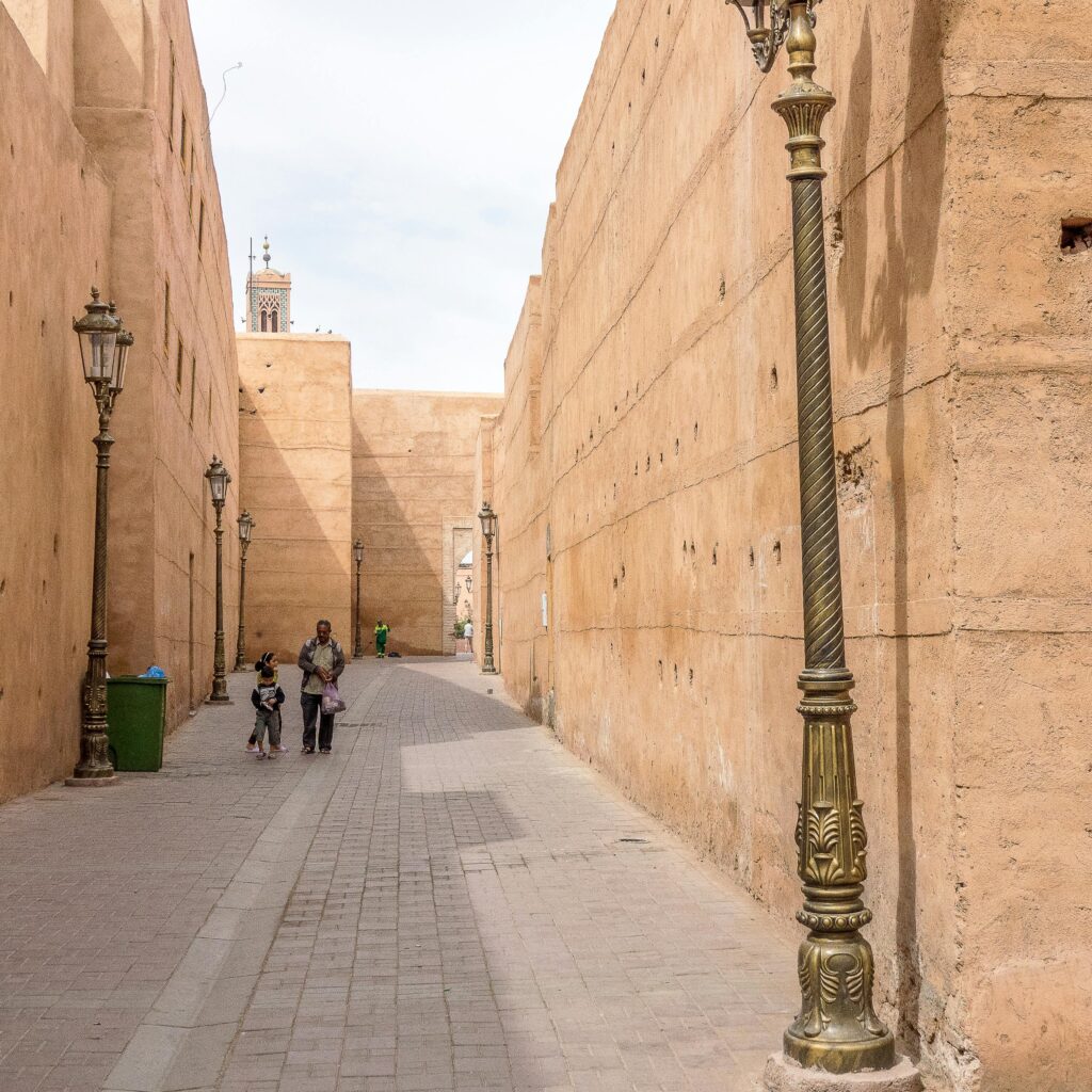 Thick kasbah walls with lamp-lit alley