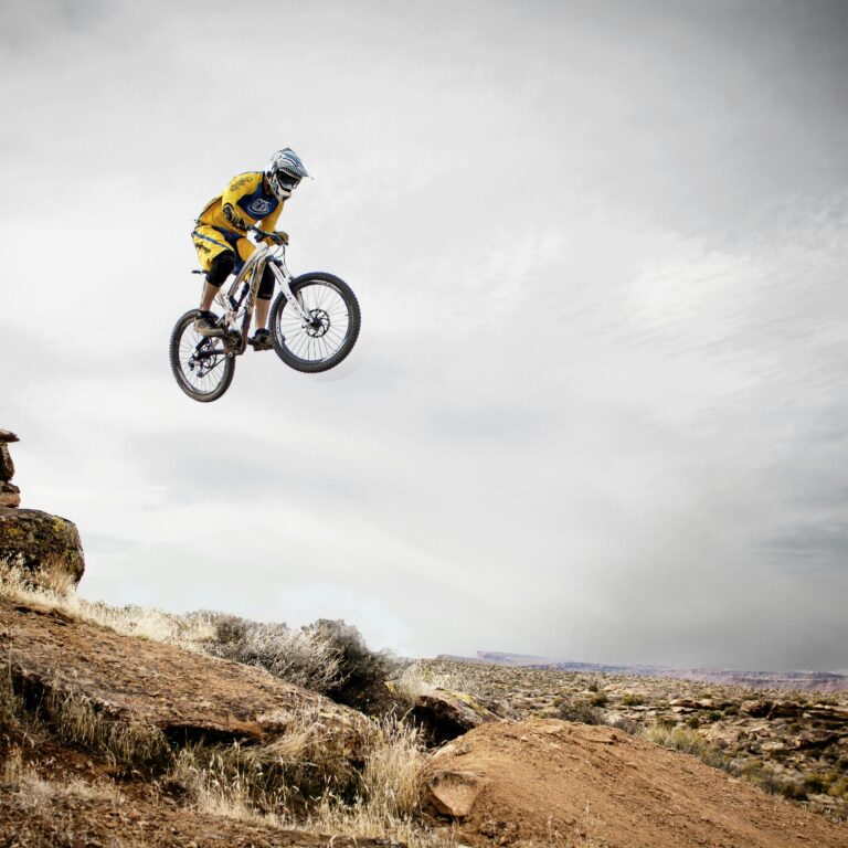 Cyclist in mid-air jump on trail