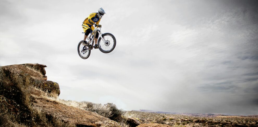 Cyclist in mid-air jump on trail