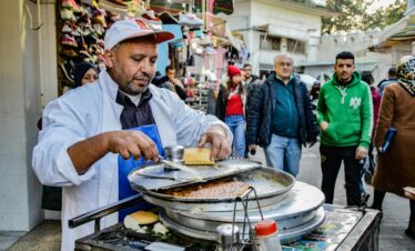 Vendor preparing traditional Moroccan food