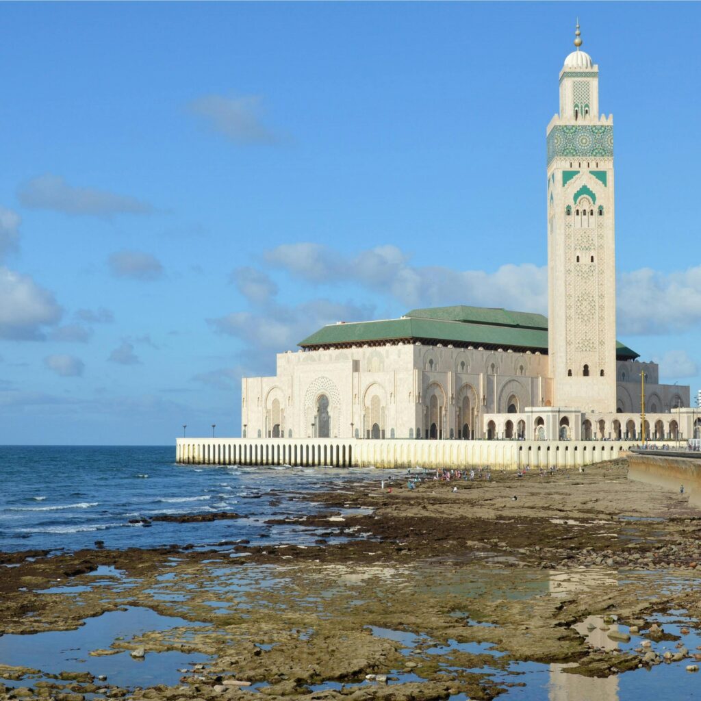 The mosque beside ocean rocks and shallow water