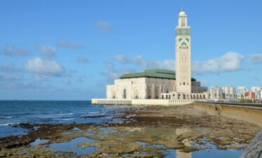 The mosque beside ocean rocks and shallow water