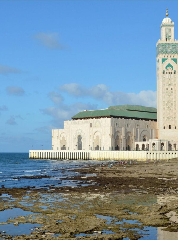 The mosque beside ocean rocks and shallow water
