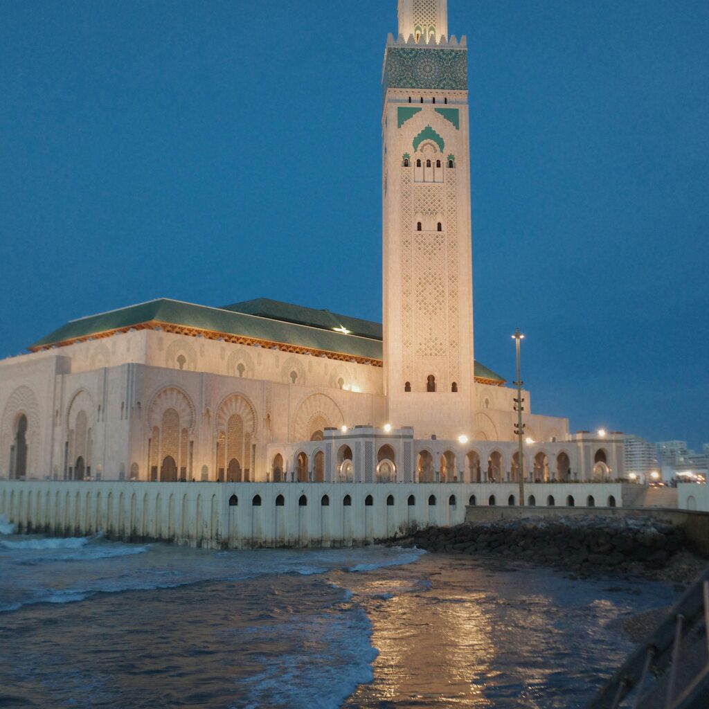 Grand mosque with tall minaret near sea