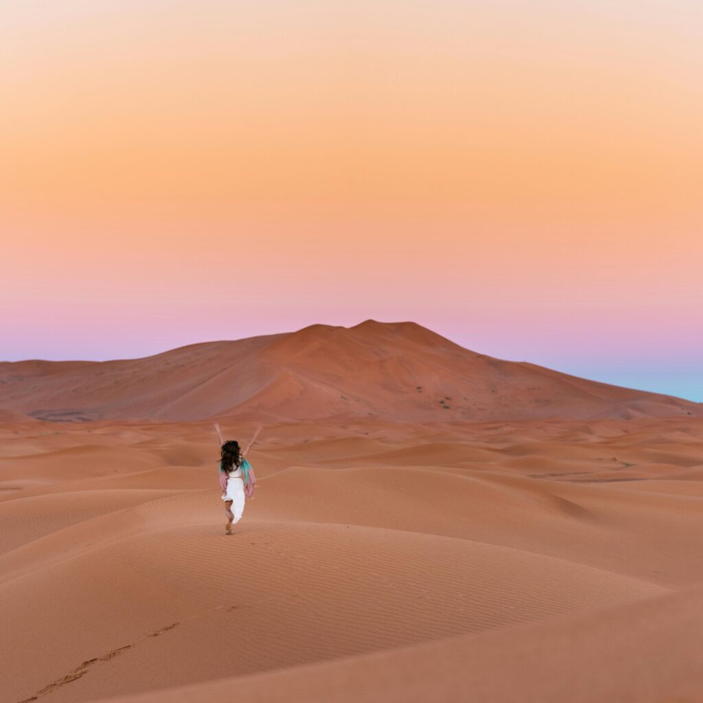 Rolling sand dunes under a blue sky