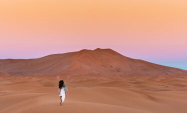 Rolling sand dunes under a blue sky