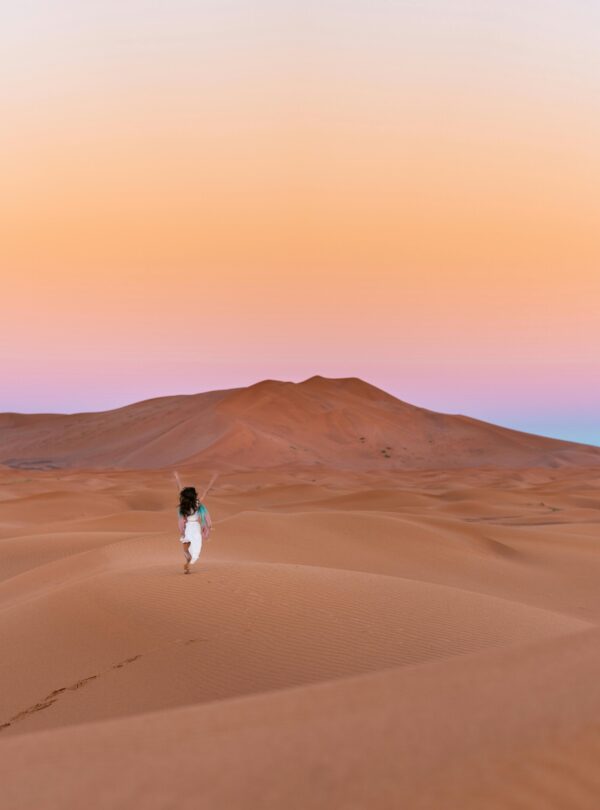 Rolling sand dunes under a blue sky