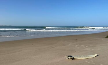 Vast empty beach with calm waves