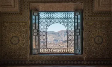 Ornate window overlooking Moroccan hills