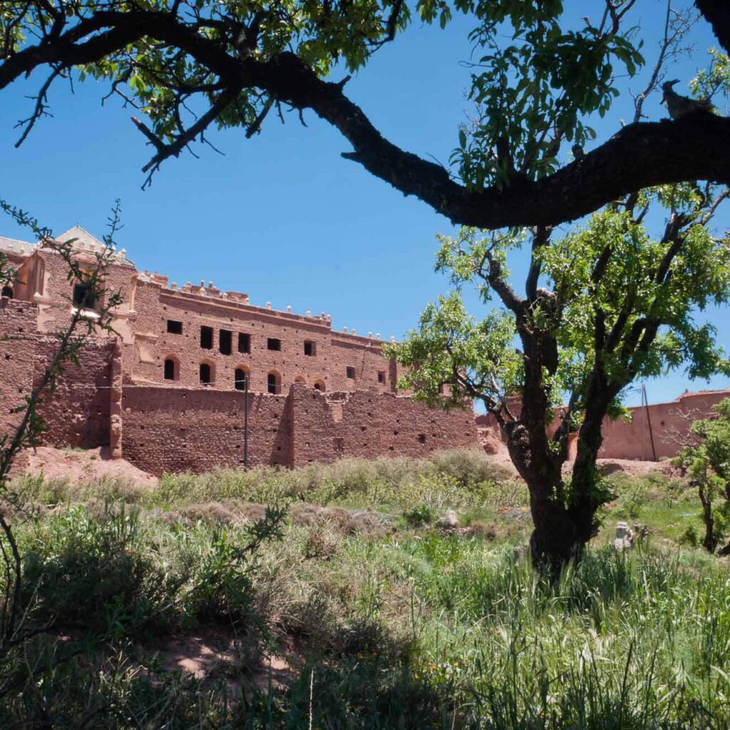 Ancient Moroccan building surrounded by greenery