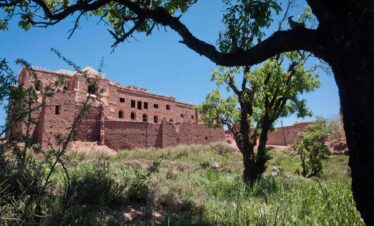 Ancient Moroccan building surrounded by greenery