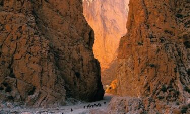 Orange cliffs of Dades Gorge glowing in sunset light.