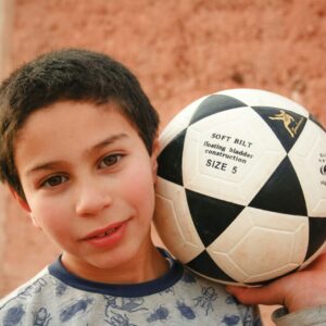 a boy holding a football ball Morocco Soccer