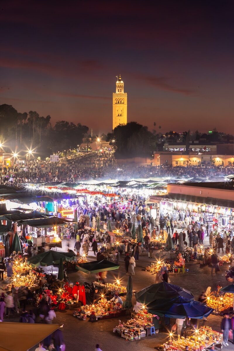 Film Festival Marrakesh A crowd of people standing around a market at night