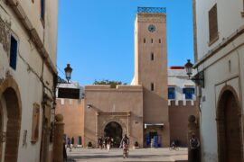 Ancient Libraries of Morocco A moroccan landmark with arches and a clock tower.