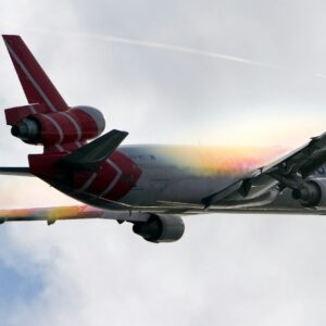 white and red airplane under white clouds during daytime