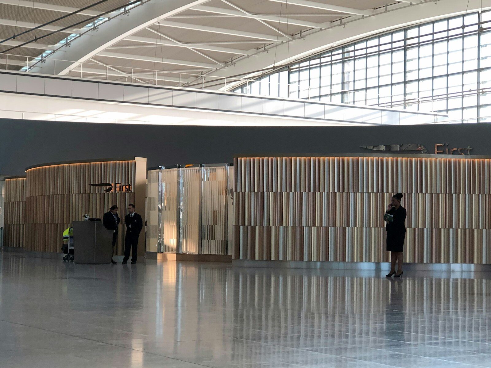 VIP Airport man in black shirt walking on white floor tiles