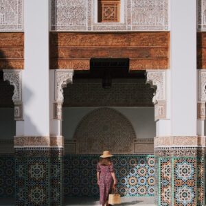Expats in Morocco a woman in a hat standing in front of a building