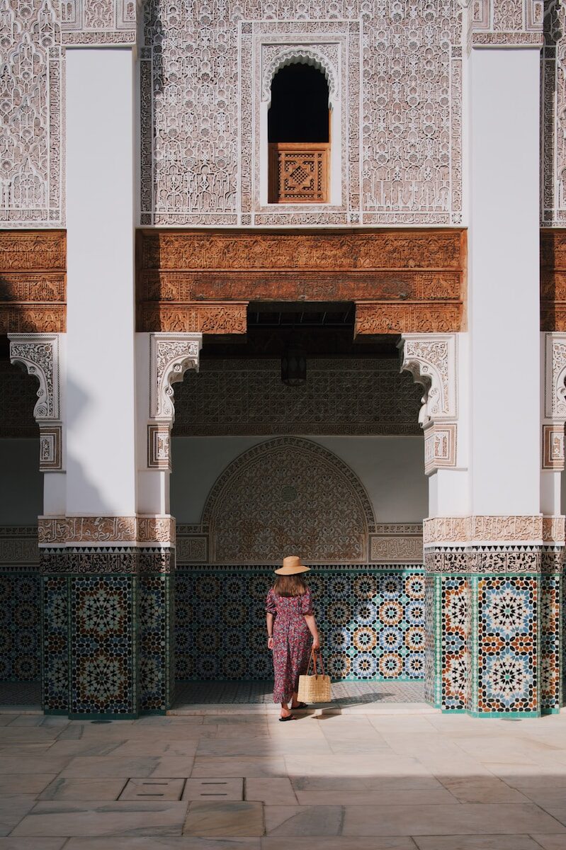 Expats in Morocco a woman in a hat standing in front of a building