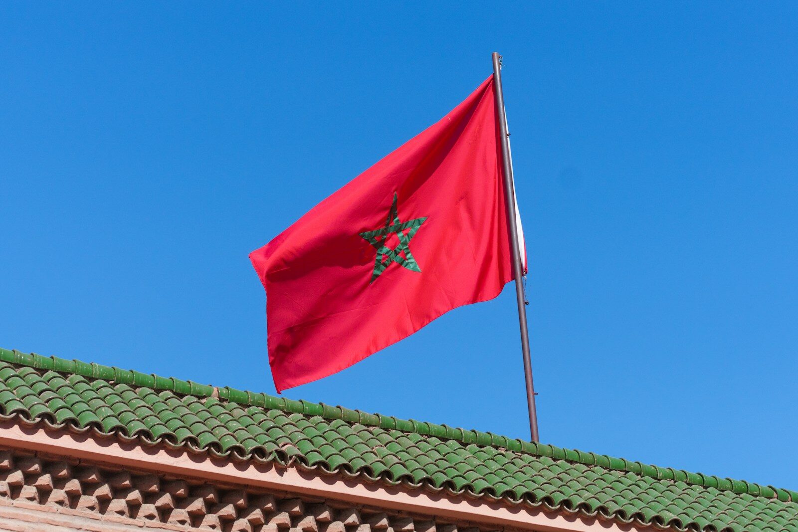 Visa Updates for Morocco A red flag flying on top of a building