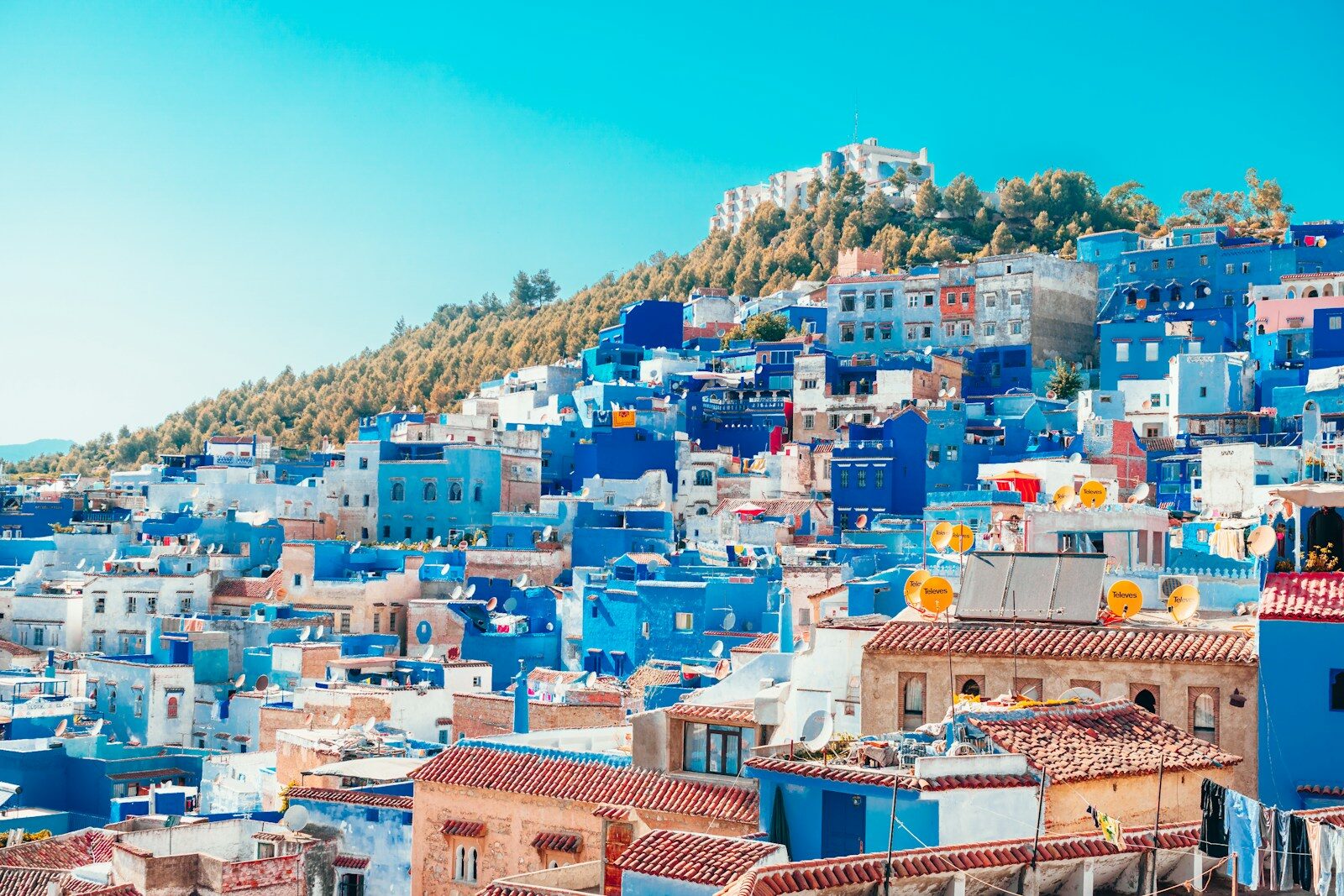 Morocco blue and white painted houses on the cliff