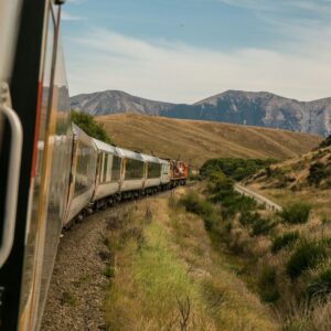 white train with the distance of mountain during daytime