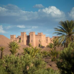 Film Production Locations Morocco brown concrete building in desert beside palm trees