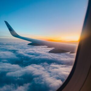 New Flight a view of the wing of an airplane as it flies above the clouds