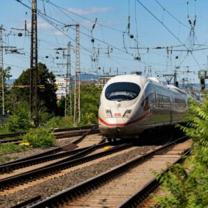 High-speed Train Routes Morocco A white train traveling down train tracks next to a forest