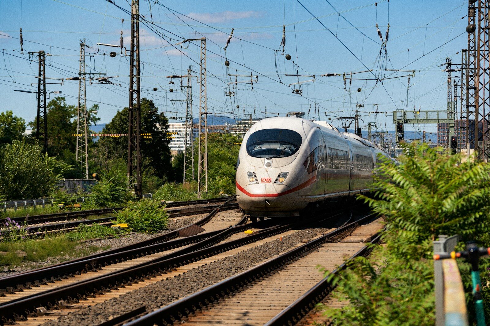 High-speed Train Routes Morocco A white train traveling down train tracks next to a forest