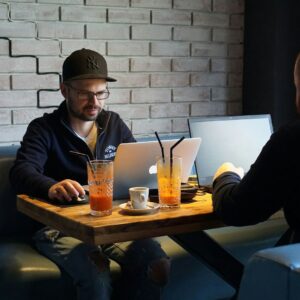 Digital Nomad Life a group of men sitting at a table with drinks