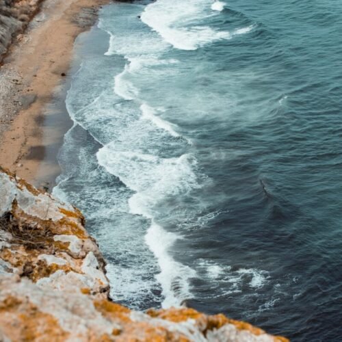 a rocky beach with waves crashing