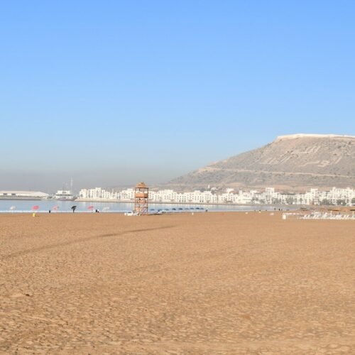 a beach with a mountain in the background