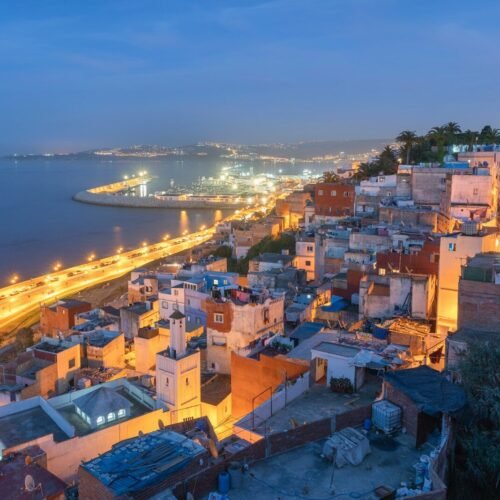 aerial view of city near body of water during night time