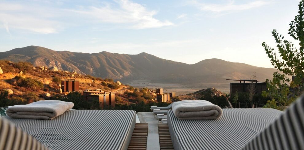 sunloungers fronting buildings near mountain
