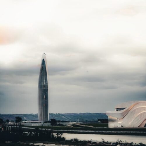 A large building with a very tall tower in the background
