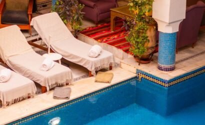 a large swimming pool with lounge chairs around it