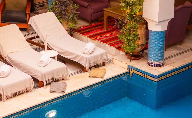 a large swimming pool with lounge chairs around it