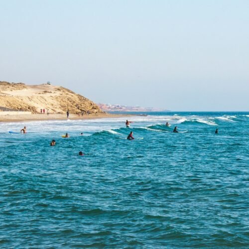 people riding surfboards in ocean at daytime