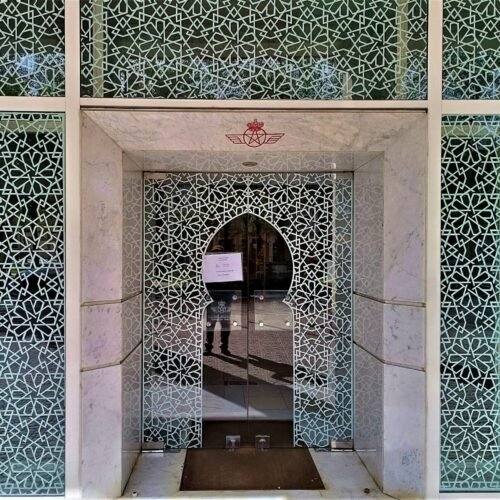 the entrance to a building with a decorative wall