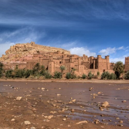 a large brown building sitting on top of a hill