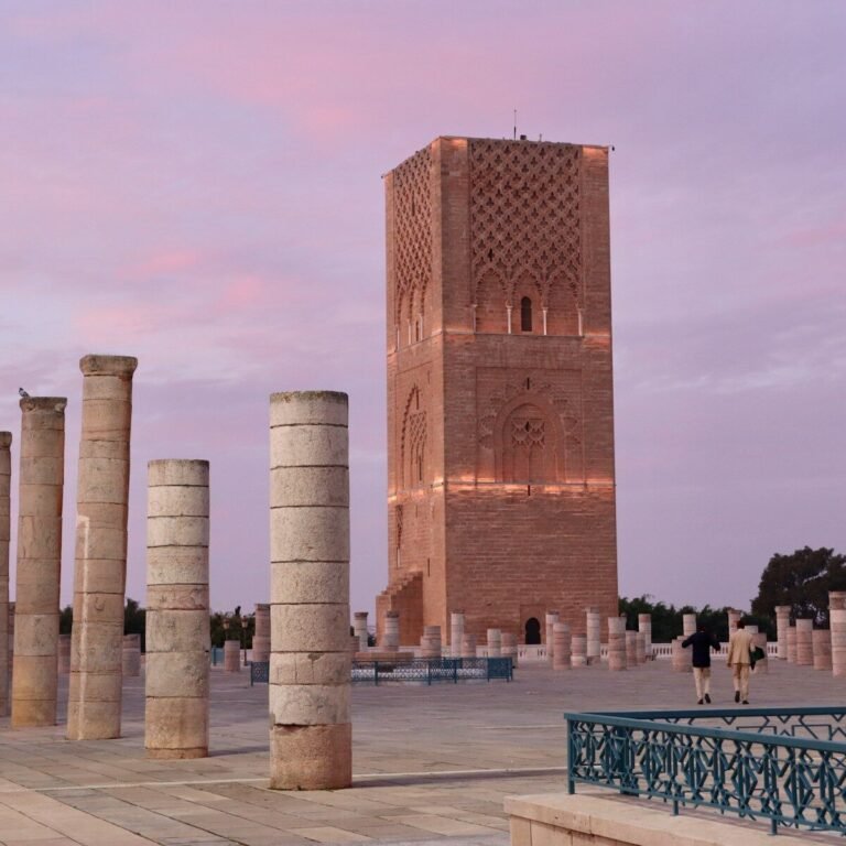 A group of pillars sitting next to a tall building