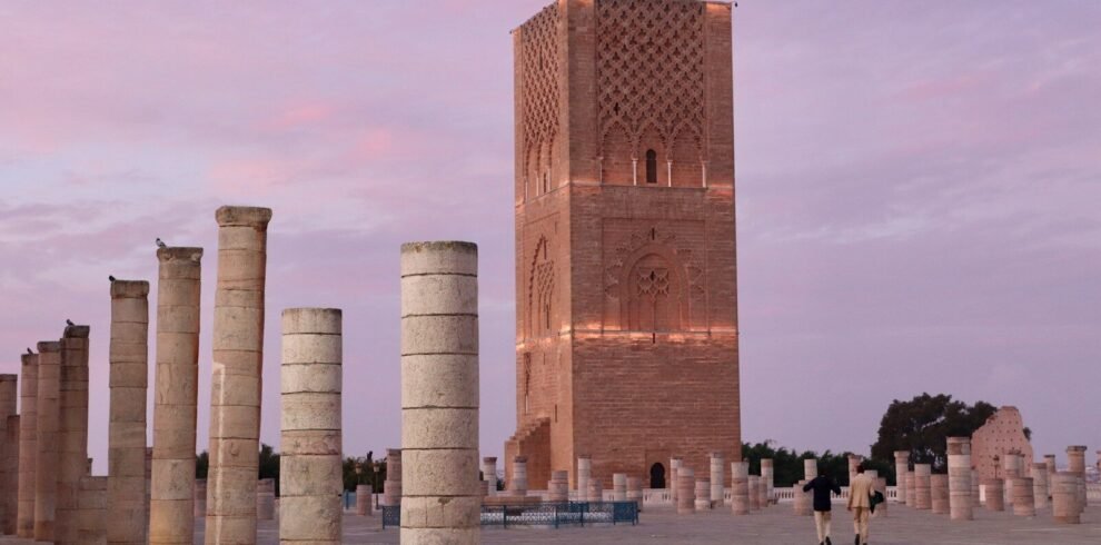 A group of pillars sitting next to a tall building
