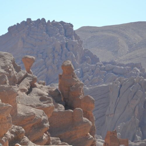 a man standing on top of a rock formation