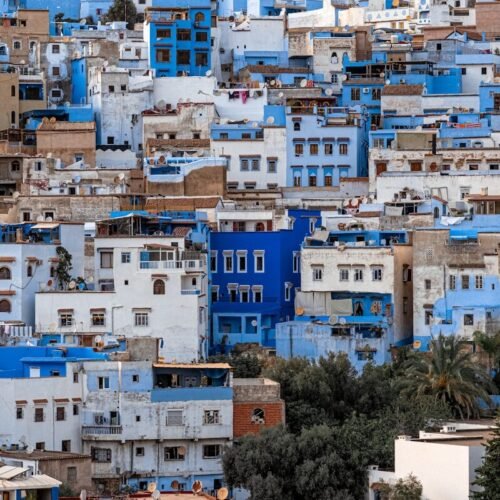 a city with lots of blue buildings on top of it