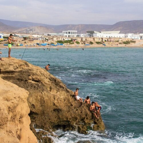 group of people climbing on cliff