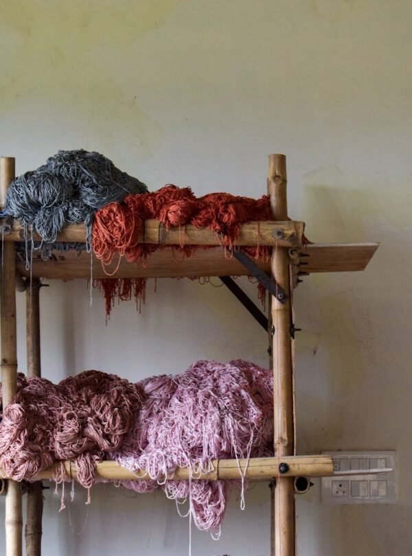 Bunches of colorful yarn on a wooden shelf