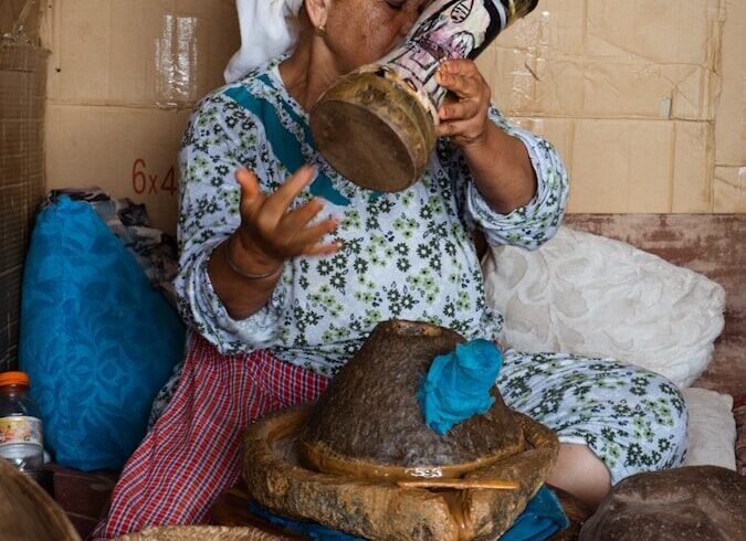 Woman in headscarf holding decorated vase toasting tool