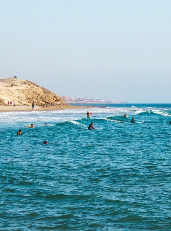 people riding surfboards in ocean at daytime
